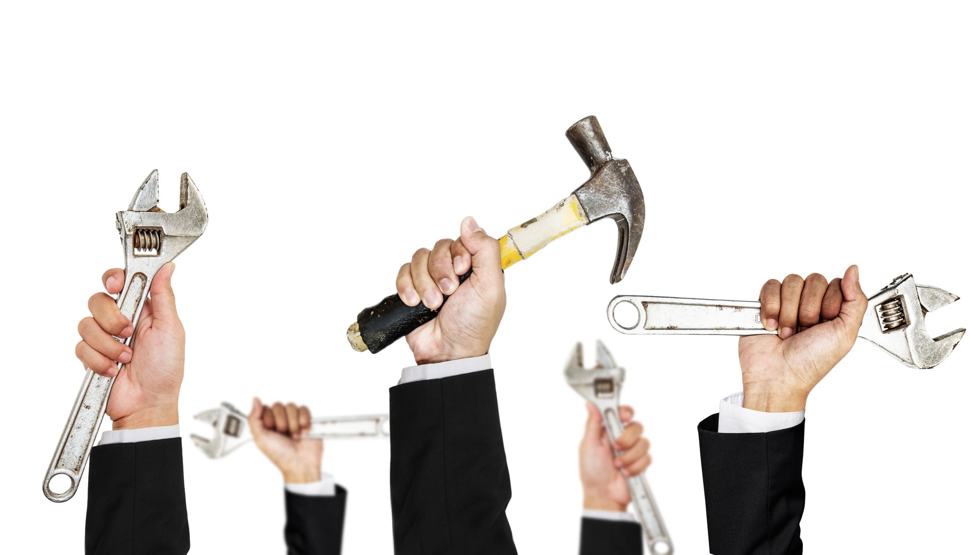 Hand in black suit holding various tools raised up, isolated