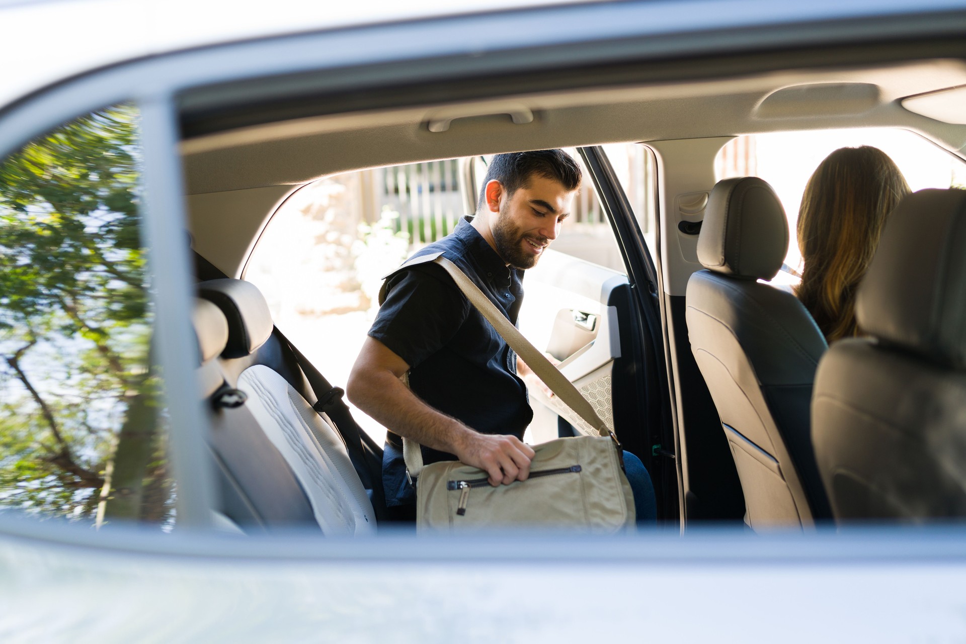 Happy driver picking up a new passenger